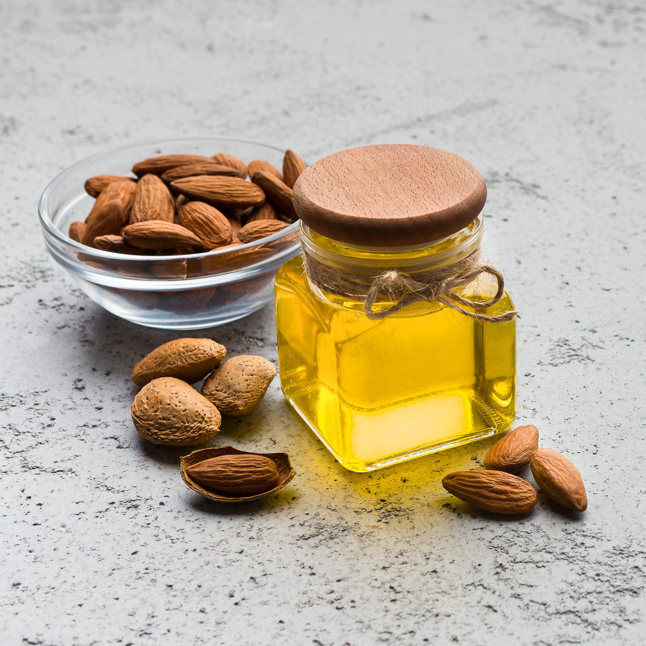 Almond oil and bowl with almonds