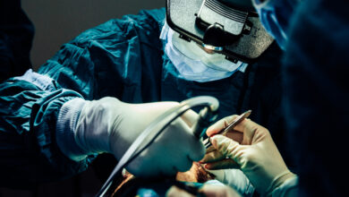 Close up doctor with surgical tools making surgery in the operating room, baldness treatment, hair transplant